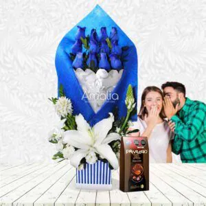 🌹 Arreglo floral con rosas azules, lirios blancos y chocolates gourmet. Un regalo único y elegante.