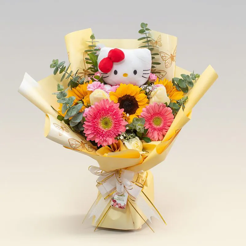 Ramo amarillo con girasoles, gerberas y peluche Hello Kitty sobre fondo neutro
