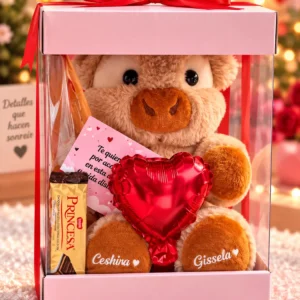 Vaquita en caja transparente con lazo rojo, chocolate Princesa y globo corazón.
